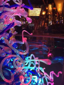 A glass sculpture lit with lights giving it the notion of glowing. 