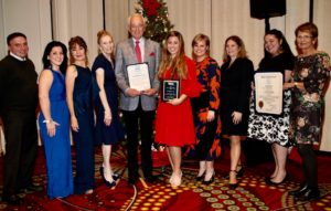 The Whaler's Inn team poses with plaques and awards. 
