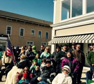 A group of spectators wash as a Parade goes by, 