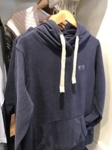 A blue hooded pullover sweatshirt with the word Mystic printed on the left chest. 