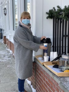 Jackie Johnson serves hot chocolate during the Churros and Hot Chocolate fundraiser in stonington, ct while supporting our local community