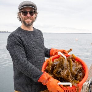 Chef David holding up kelp-a sustainable seafood